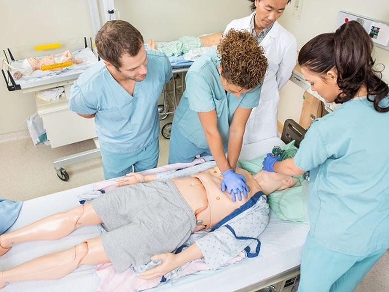 picture of nurses and medical staff in a classroom sim lab